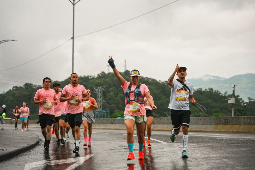 Vibrant marathon runners on a rainy day demonstrating teamwork and endurance outdoors.