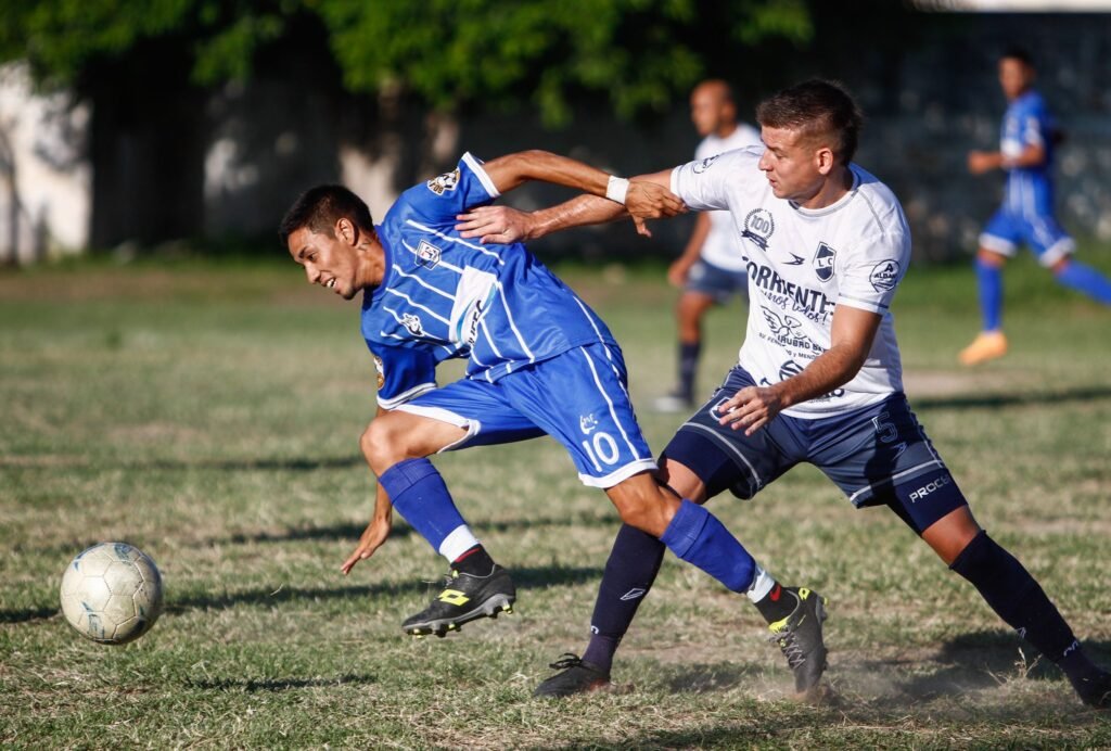 Dynamic action shot of players competing in a lively soccer match outdoors.